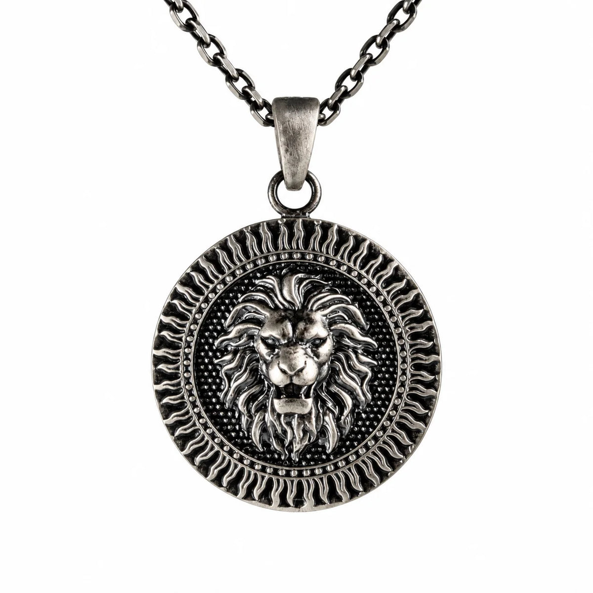 A silver-toned round pendant necklace featuring a detailed lion head design in the center, suspended from a matching chain against a plain white background.