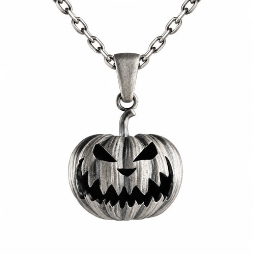 A silver-toned metal pendant necklace featuring a carved jack-o'-lantern pumpkin design with black recessed details, suspended from a matching chain on a plain white background.