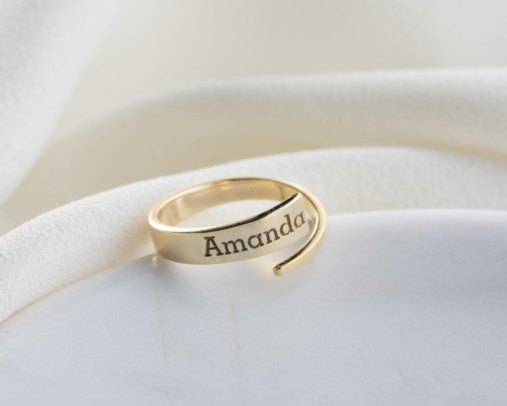 gold spiral name ring “Amanda” on bright background