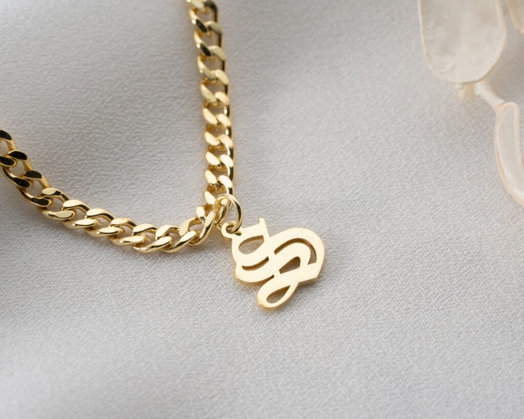 gold-plated initial anklet on ankle close-up