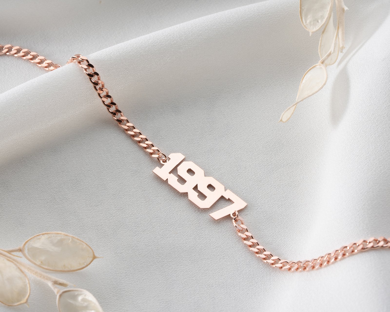 rose gold “1997” anklet on ankle close-up