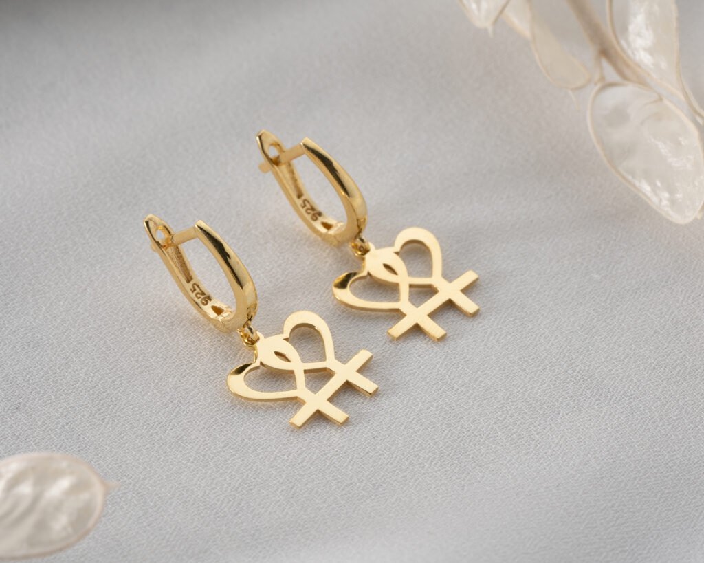 Gold heart and female symbol earrings