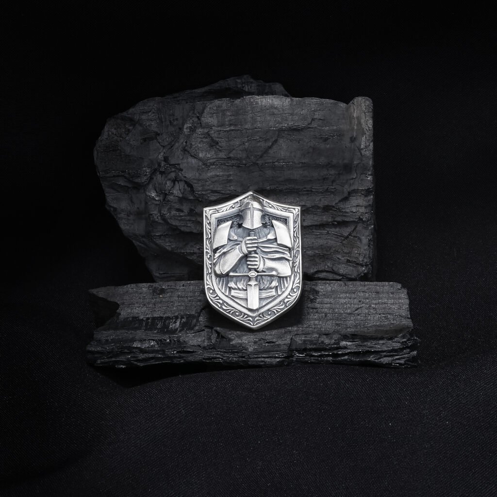 antique silver knight shield ring on dark textured background