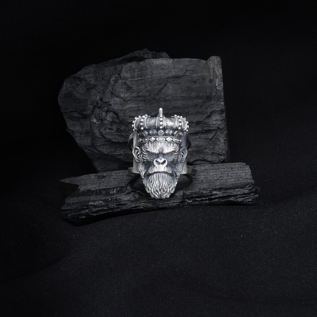 antique silver king ape ring on dark textured background