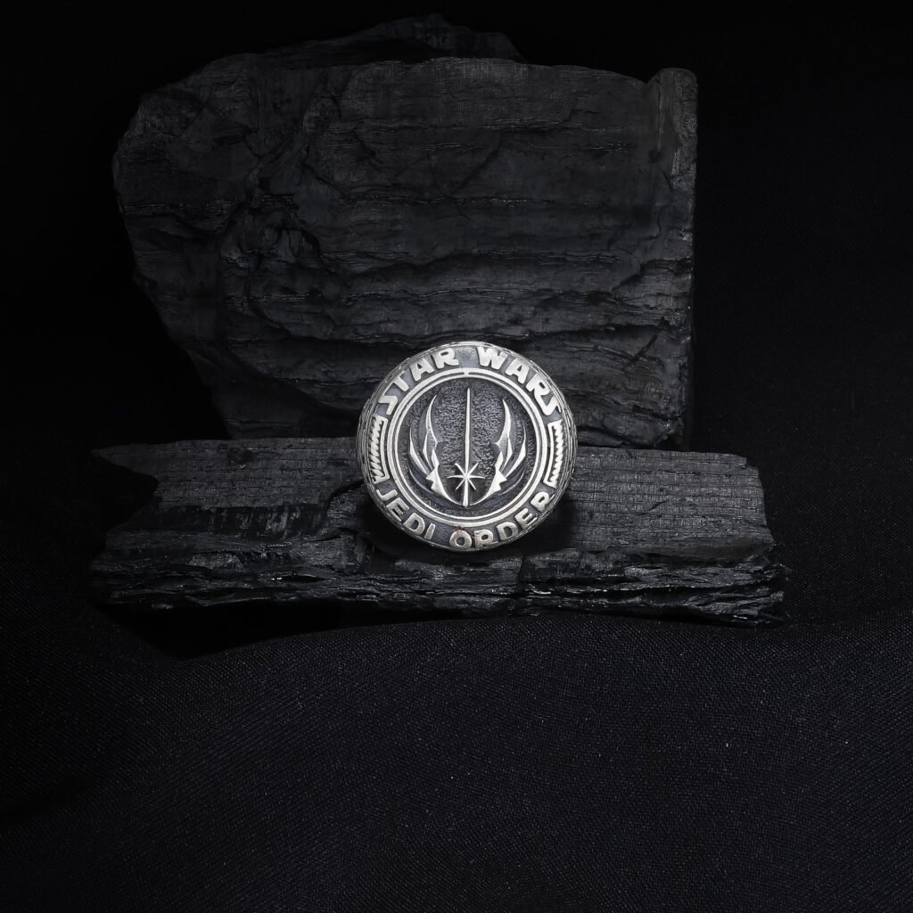 antique silver galactic emblem ring on dark textured background